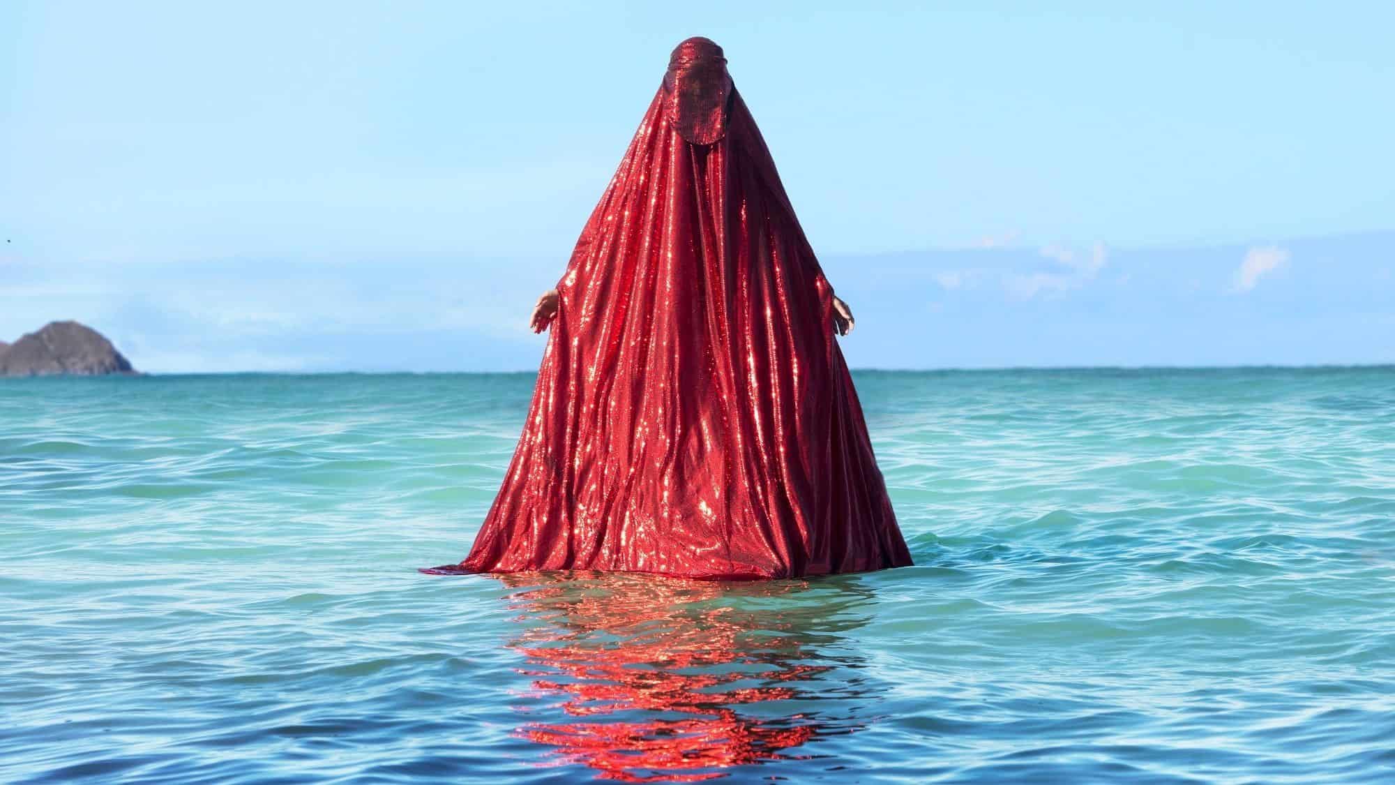 essentials-fave-5-The Red Chador_Water Birth-16-9-2000x1125-min Water Birth, The Red Chador: Genesis I, Kaiona Beach, Oahu, Usa, 2019, Anida Yoeu Ali, Cambodian American, B. 1974, Archival Inkjet Print, Image Courtesy Of The Artist, © Studio Revolt
