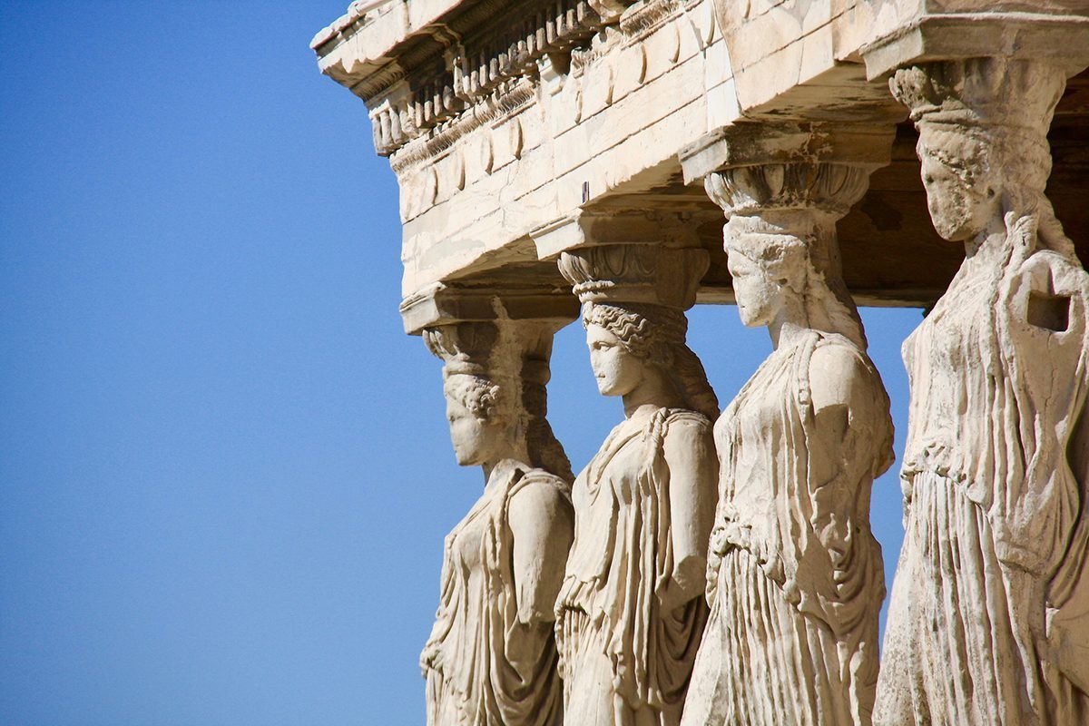 Low Angle View Of Statues At Old Ruins Against Clear Sky Photo Taken In Athens, Greece
