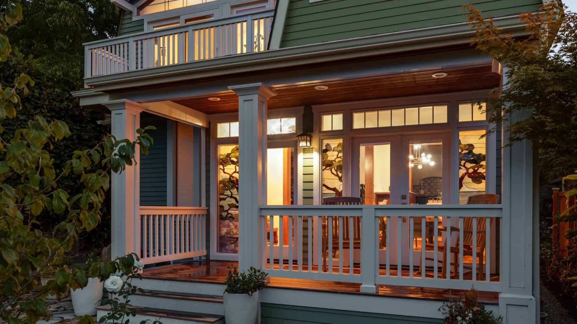 living-Miranda-Estes-Photography-Balakrishnan-Exterior-21-16-9-2000x1125-min View of the front porch of a house located in Capitol Hill neighborhood in Seattle. The image was taking at night and the outside lighting reflects in the warm green pistachio color of the house.